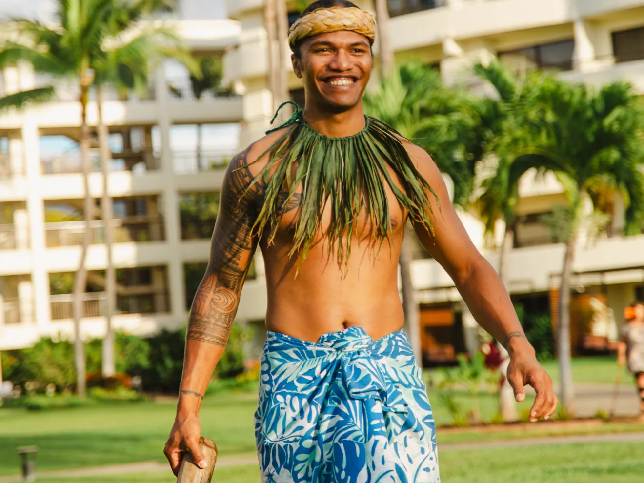 a person holding a frisbee in a park
