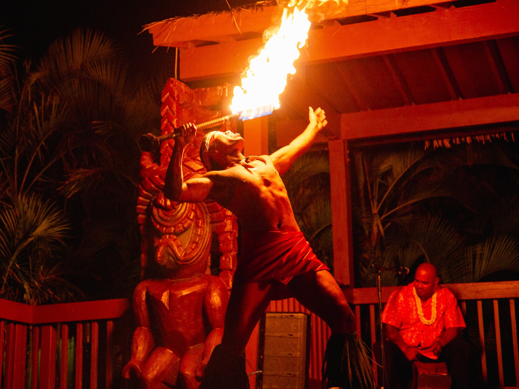 a man standing in front of a fire